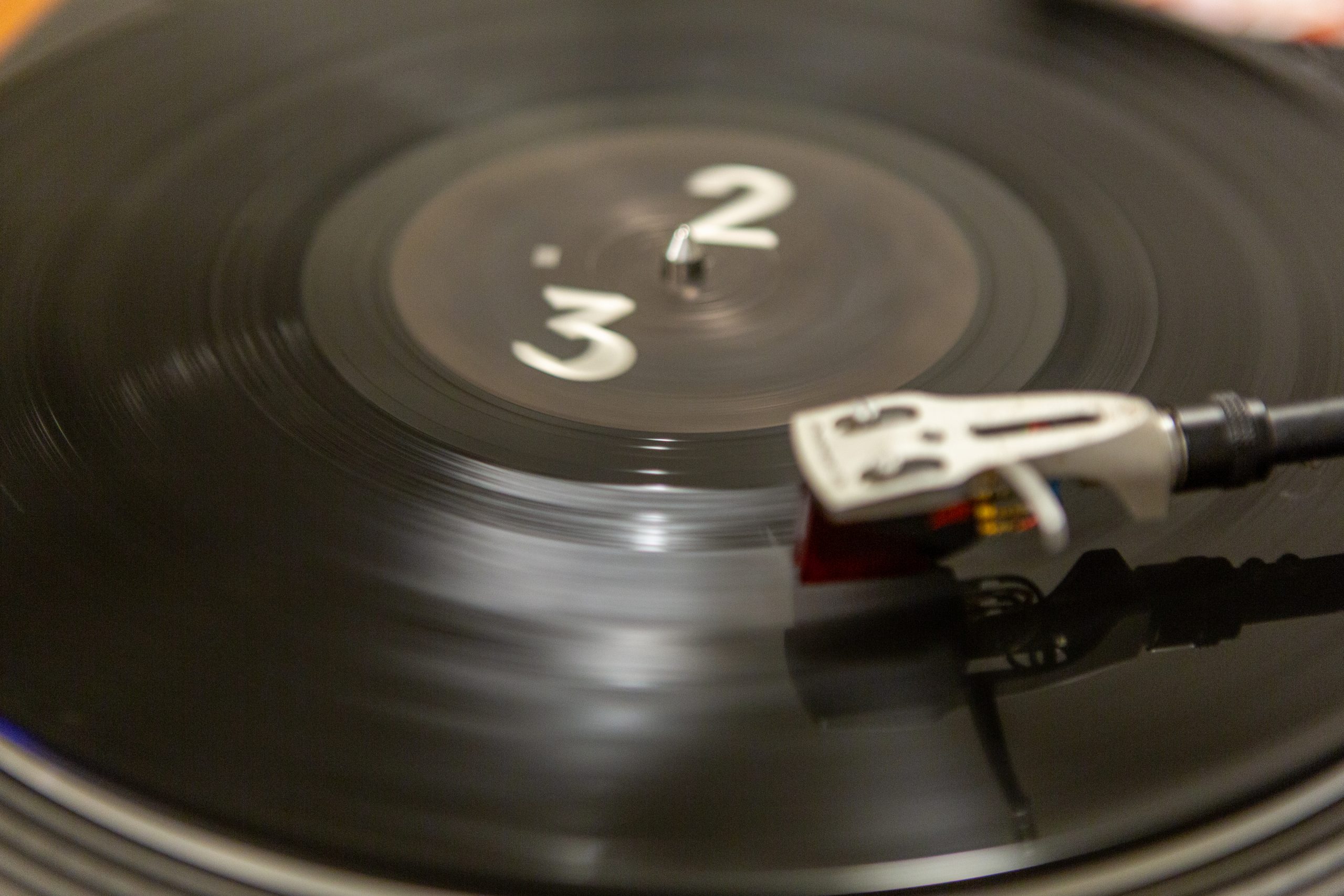 A vinyl record plays on a turntable.