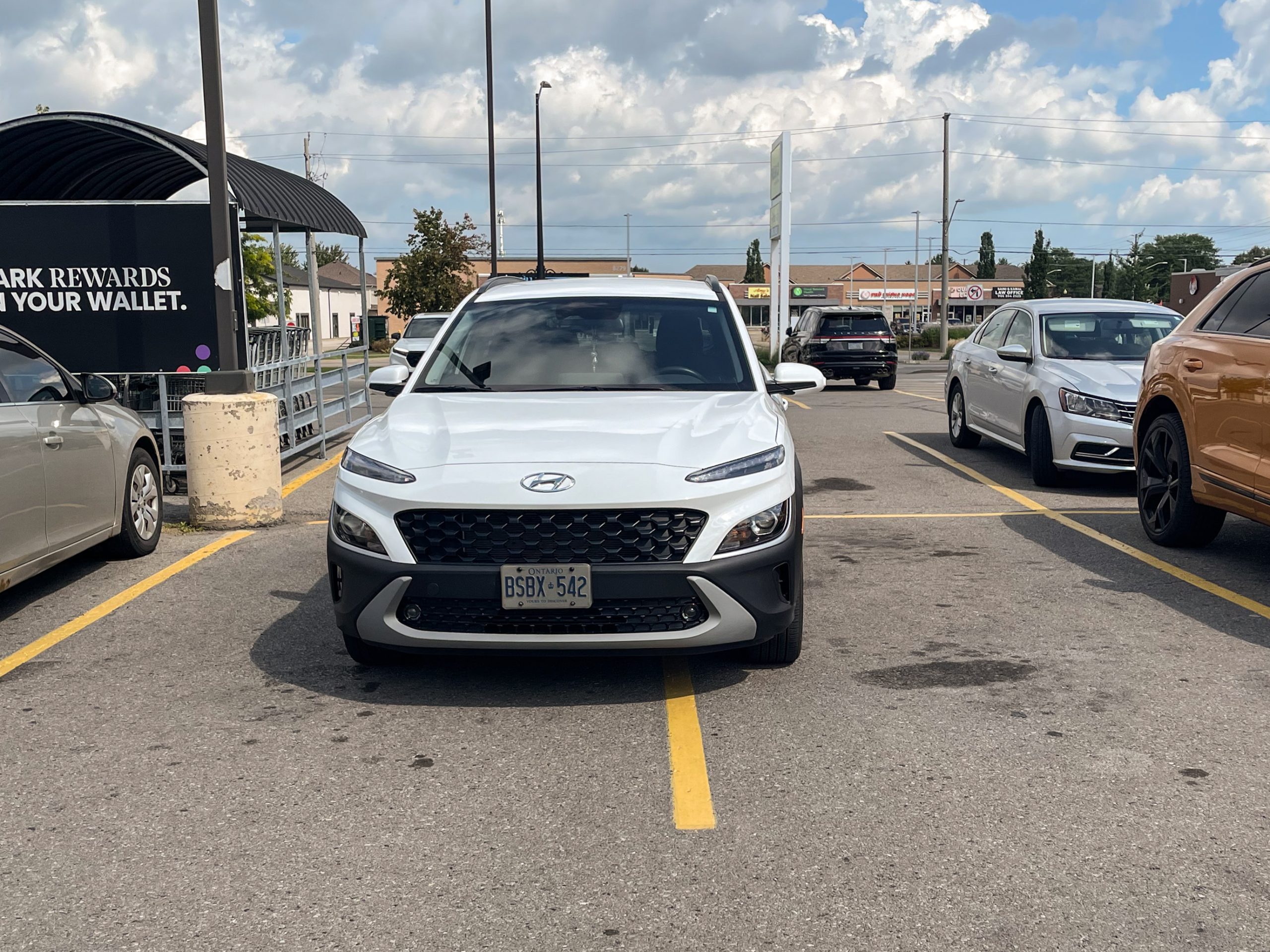 Hyundai Kona parked taking up two spots in a grocery parking lot. It's clearly not accidental.